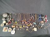 many different types of jewelry on a black table