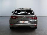 the rear end of a silver car in a white room