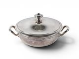 a silver pot with a lid on a white surface
