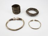 three silver bracelets and a ring