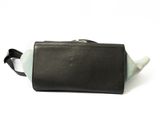 a black and white toilet bag on a white surface