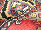a close up of a colorful rug with a tag on it