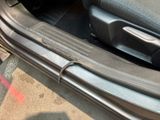 a close up of a car door handle and door sill
