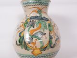 a small vase with a design on it on a white surface