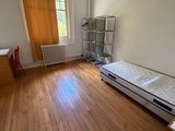 a small bedroom with a bed and a desk in it