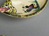 a small bowl with a cat and dog design on it