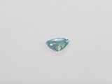 a blue topazte gems on a white surface