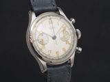 a close up of a watch on a black background