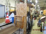 a room filled with lots of furniture in a warehouse