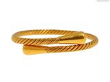 gros plan d'un bracelet en or sur fond blanc