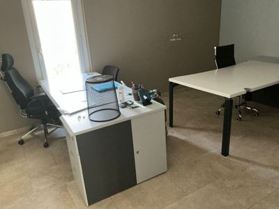 a desk with a chair and a computer on it in a room