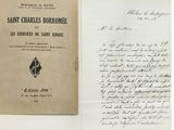 an old book with a handwritten letter on it sitting on top of a piece of paper