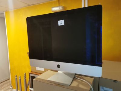 a computer monitor sitting on top of a desk