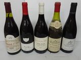 six bottles of wine are lined up on a table