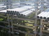 a lot of pipes that are stacked up on the ground