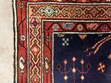 an image of a blue and red rug on a white floor