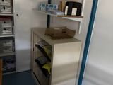 a small room with shelves and a desk in it