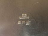 a close up of a silver plate with a number on it