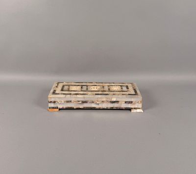 an old wooden box sitting on top of a white table