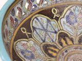 a close up of a decorative bowl on a table