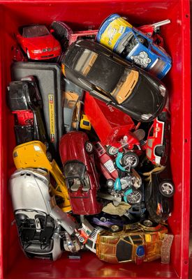 a red box filled with assorted toy cars
