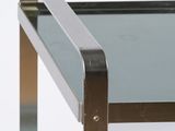 a close up of a glass table with a metal frame
