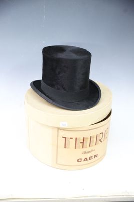 a black top hat sitting on top of a white box
