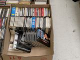 a lot of dvds in a box on the floor