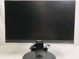 the dell monitor is sitting on a stand on a white surface