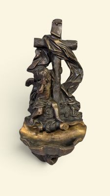 statue en bronze représentant Jésus portant la croix, assis sur un rocher en compagnie d'un chien