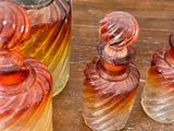 bottles of perfume sitting on top of a wooden table next to each other