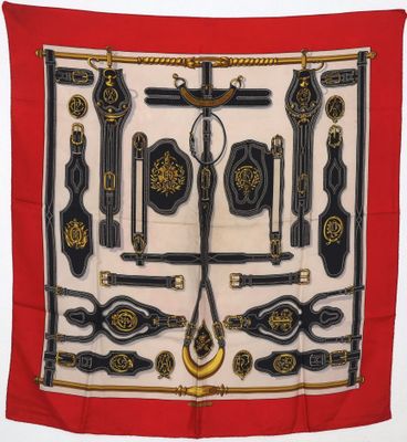 an image of a red scarf with a bunch of different items on it