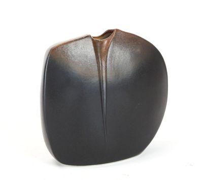 a black vase that is sitting on a white surface