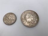 two silver coins, one of which has been struck and the other one has been struck