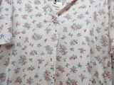 a white shirt with pink and blue flowers on it