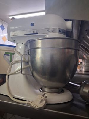 a white mixer on a counter in a kitchen