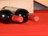 two bottles of wine sitting next to each other on a table