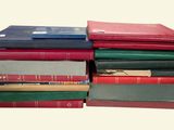 many books stacked on top of each other on a table