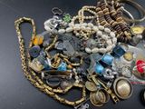 a pile of assorted jewelry sitting on a table