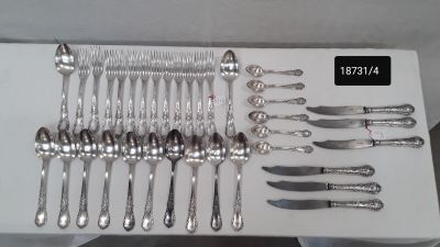 a lot of silverware on a table with a price tag