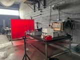 a photo of a room with a table and a red screen