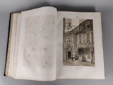 an open book with a picture of a building in the background