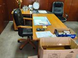 boxes are stacked on a desk in an office with a clock