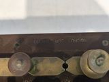 a close up of a metal plate with two knobs on it