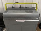 an image of a cooler sitting on top of a tiled floor