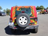 a red and yellow jeep parked in a parking lot