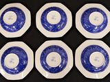 six plates with blue and white designs on them on a black surface