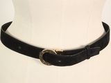 a black belt with a gold buckle on a mannequin