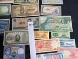 many different types of foreign currency displayed on a table