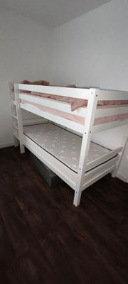 un lit superposé dans une petite chambre avec un parquet